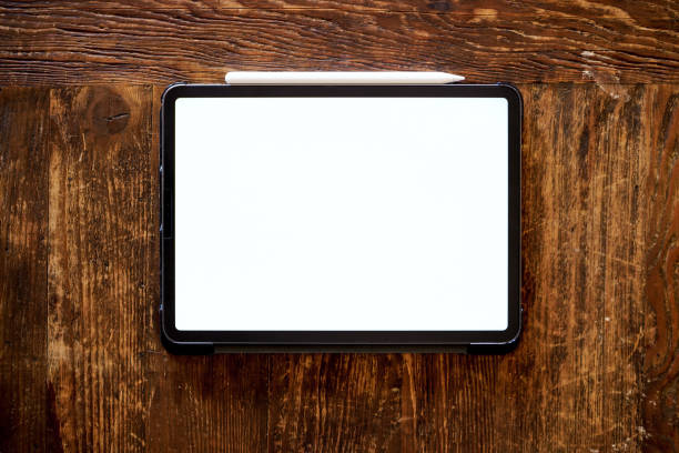 istock pro tablet with pencil flat lay on wooden table 1266744230