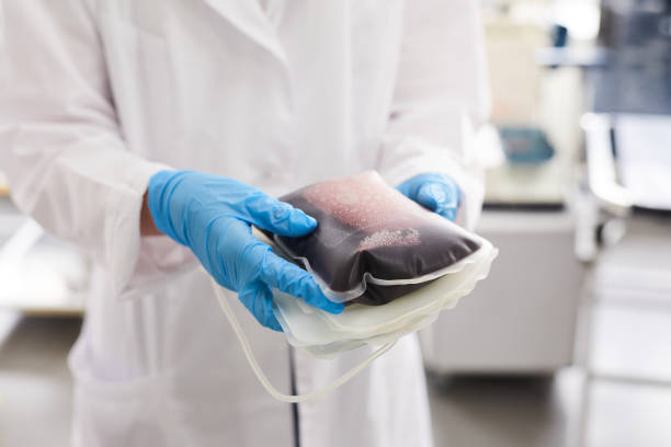 médico segurando pacote com sangue - genetic research men chemical protective glove - fotografias e filmes do acervo