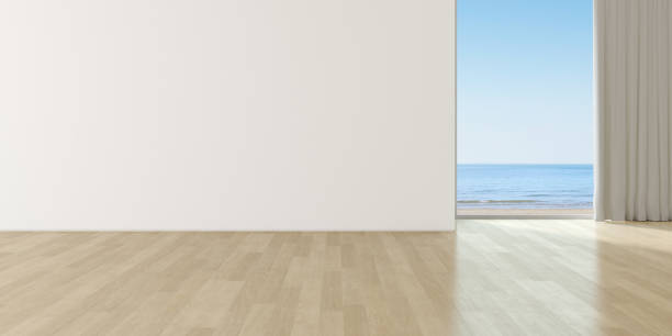 istock Modern empty room with wooden floor and large plain wall on sea background. 3d render. 1266747167