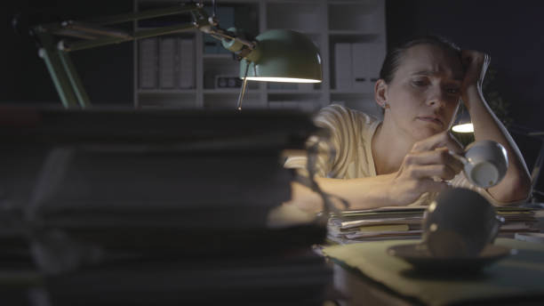 istock Frustrated woman working in the office at night 1266748709