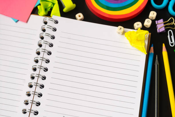 istock Opened notebook page. Back to schoolconcept with colorful pencils, rainbow eraser, notebook, sticky notes and office supplies. Flat lay. 1266749698