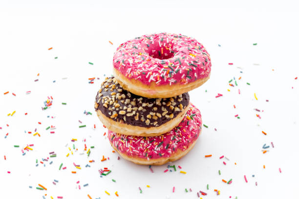 istock Colorful donuts close up, glazed and sprinkles bakery 1266749907