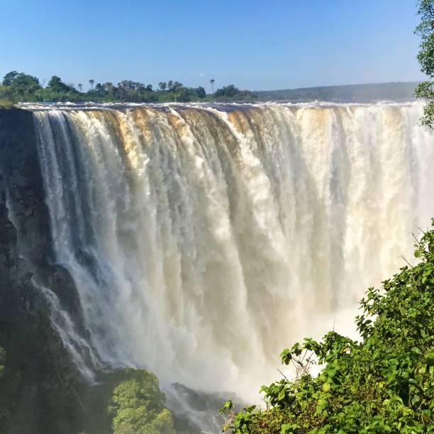Victoria Falls with high water level, Zimbabwe Detail of Victoria Falls aka Mosi-oa-Tunya with high water level, view from the Zimbabwe side lake kariba stock pictures, royalty-free photos & images
