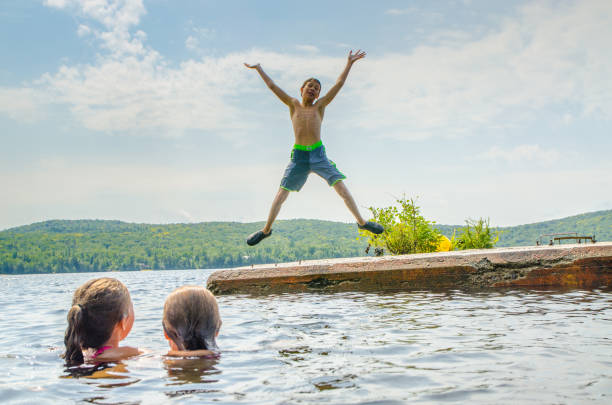 istock Boy plunging in water lake 1266750246