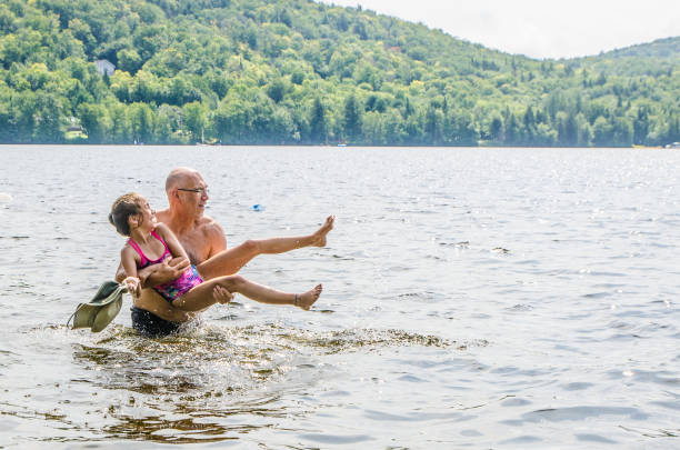 istock Father holding daughter in lake 1266751410