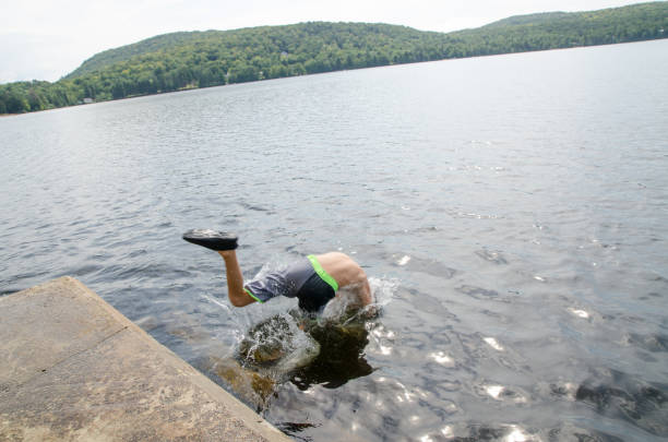 istock Boy diving in water lake 1266751695