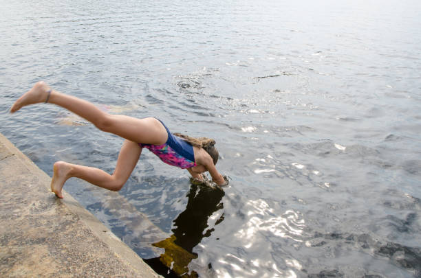 istock Girl diving in water lake 1266752002