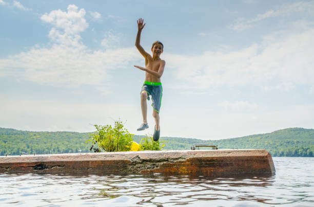 istock Boy plunging in water lake 1266752054