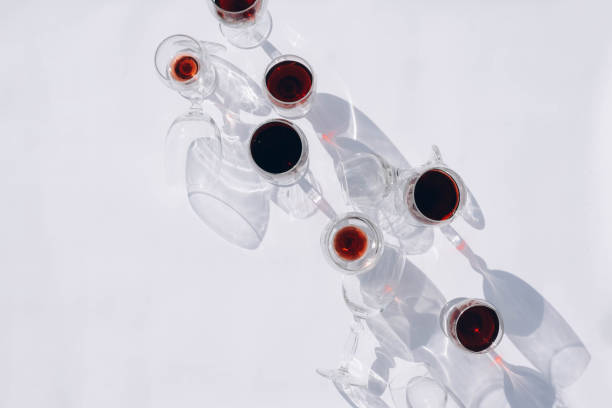 Wine of different varieties in glasses on a white background. Fashionable hard shadows from glasses.