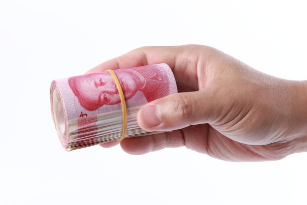 istock Man hand holding Chinese money 1266753010
