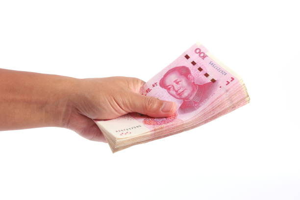 istock Man hand holding Chinese money 1266753079