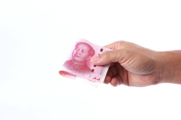 istock Man hand holding Chinese money 1266753091