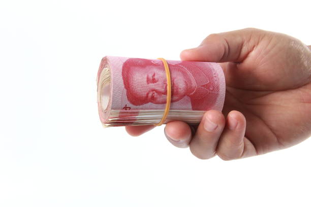 istock Man hand holding Chinese money 1266753092
