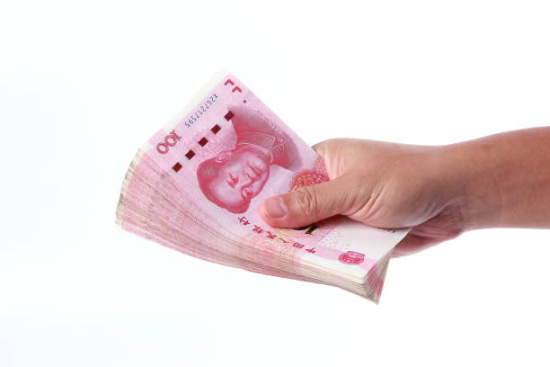 istock Man hand holding Chinese money 1266753097