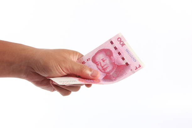 istock Man hand holding Chinese money 1266753100