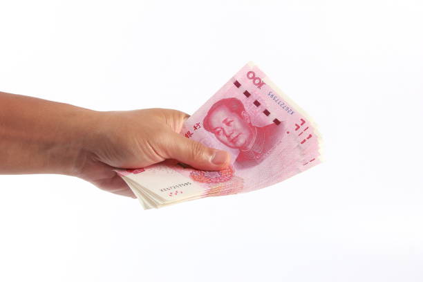 istock Man hand holding Chinese money 1266753113