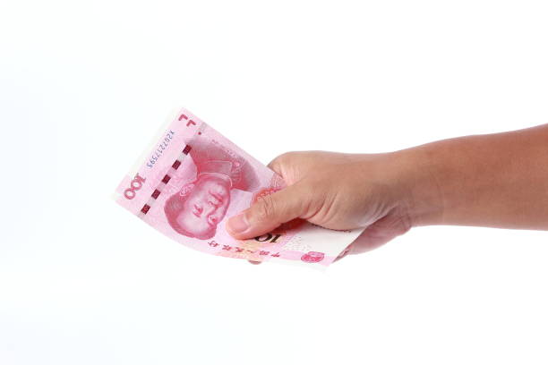 istock Man hand holding Chinese money 1266753188