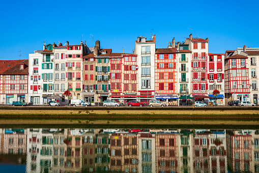 BAYONNE, FRANCE - SEPTEMBER 19, 2018: Colorful houses at the Nive river embankment in Bayonne town in France