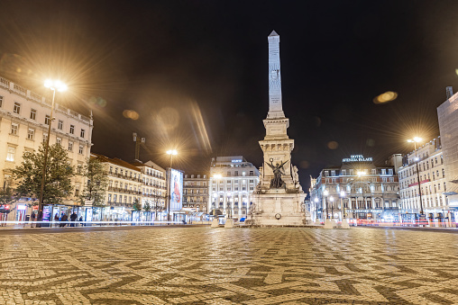November 10th, 2019 – Lisbon, Portugal: Monumento aos Restauradores at Restauradores Square in Lisbon, Portugal shot at night with car lights passing by