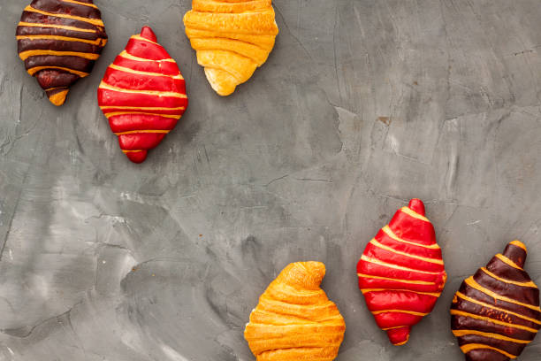 Frame of croissants - fresh bakery on dark stone background. Top view