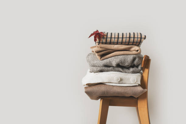 istock Autumn cozy and casual clothes stack close up on chair 1266755634