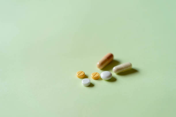 istock Multiple medications, including pills and capsules, on pastel green paper. 1266756734