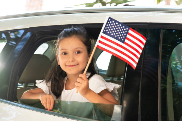 istock Girl Holding American Flag 1266757311