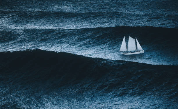 sailboat on the sea with storm and big waves sailboat on the sea with storm and big waves sailboat stock pictures, royalty-free photos & images