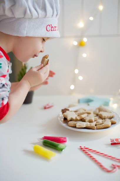 istock Child decorates Christmas cookies 1266761081