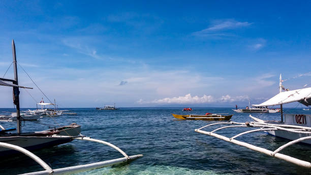 istock Docked boats in the beach coast line with clear blue sky 1266764726