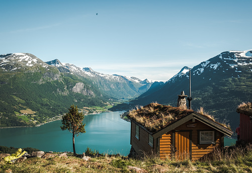 Log cabin in front of fjord by Loen in Norway.