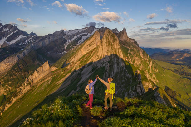 istock Drone view of hikers high five on mountain top 1266765286