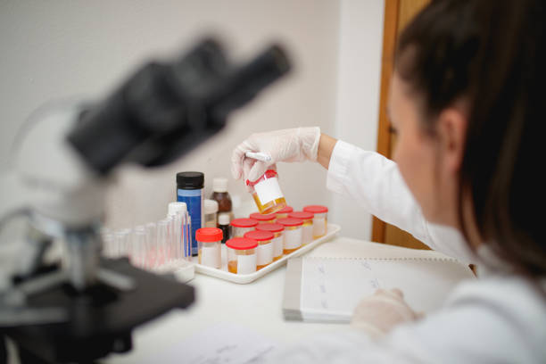 istock Wearing protective glove and holding urine sample in jar for analysis 1266765437