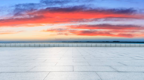 istock Empty floor and lake with beautiful clouds at sunset. 1266765573
