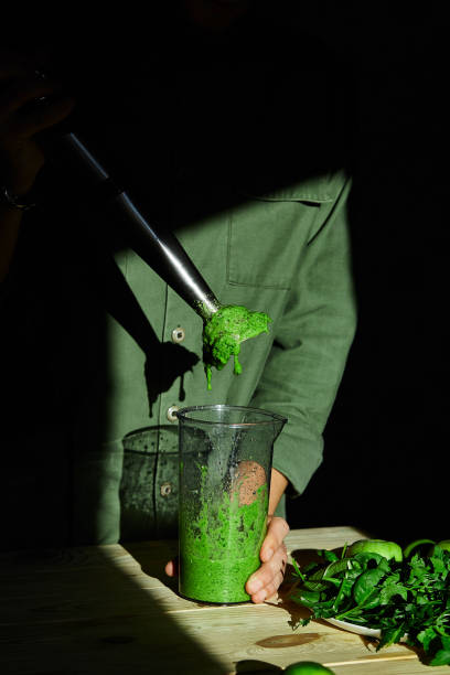 istock Process of preparing green detox smoothie with blender 1266766965