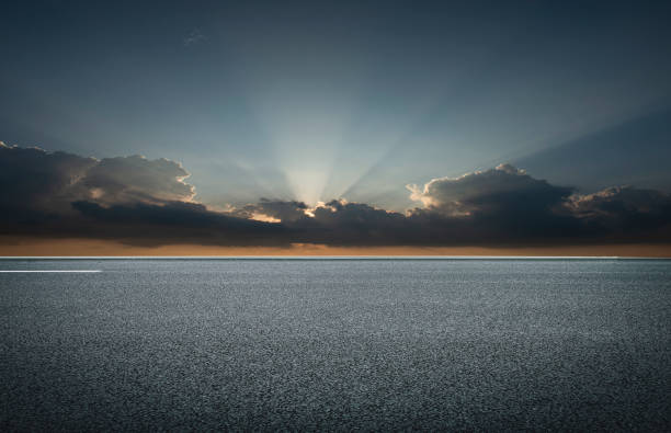 istock Evening glow, flat and wide asphalt road 1266767644