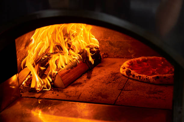 istock Italian pizza is cooked in a wood-fired oven 1266767898