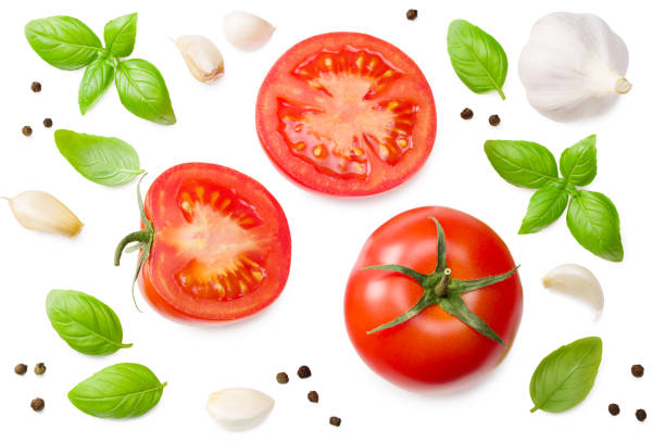 istock fresh tomato slices with garlic and basil leaves isolated on white background. top view 1266770039