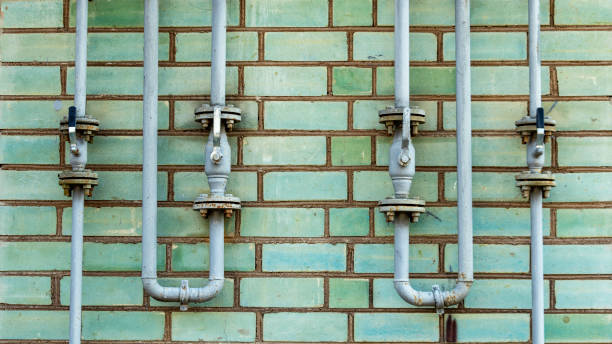 istock Pipeline with gas supply taps on a brick wall 1266775780