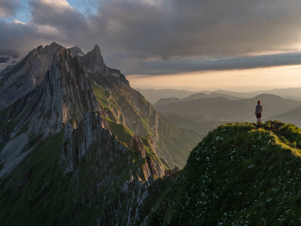 istock Man hikes in Switzerland and stops to look at view 1266778193
