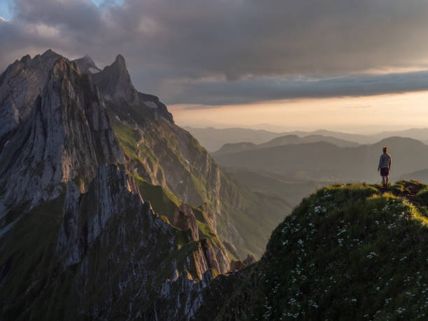 istock Man hikes in Switzerland and stops to look at view 1266778323