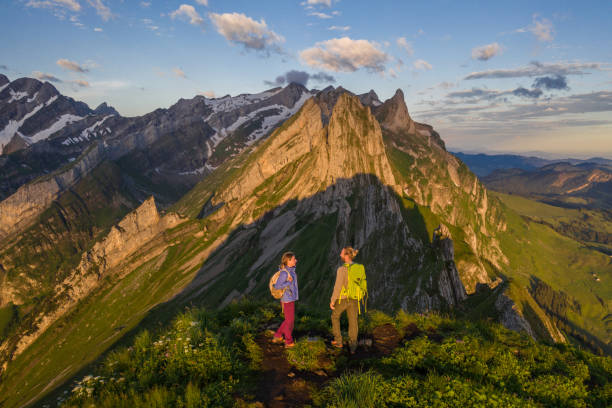 istock Drone view of hikers watching sunset from mountain top 1266778603