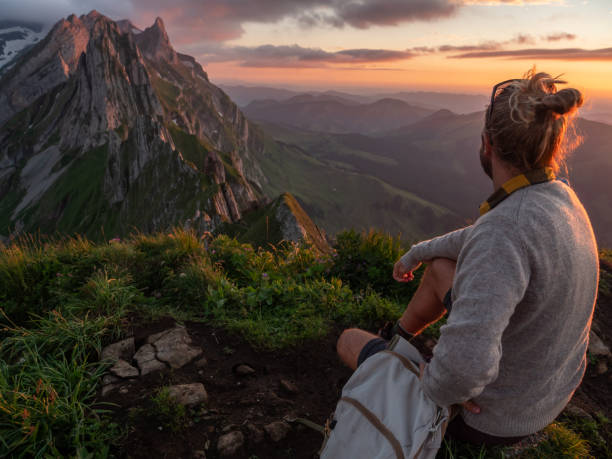 istock Man hikes in Switzerland and stops to look at view 1266778724