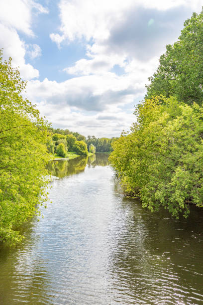istock Small river across the green banks 1266780624