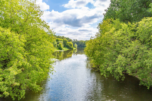istock Small river across the green banks 1266780627