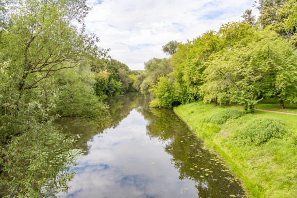 istock Small river across the green banks 1266780630