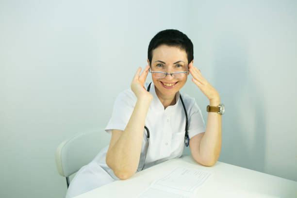 doctor is a beautician. portrait of a middle-aged woman. the doctor tells the patient about the need for facial skin care. - n64 imagens e fotografias de stock