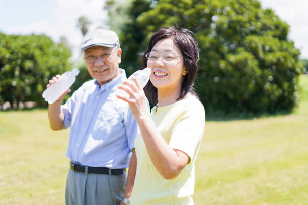 istock Old couple drinking water outside 1266782400