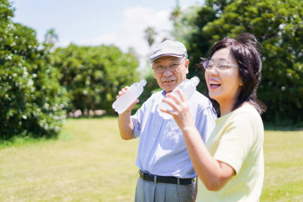 istock Old couple drinking water outside 1266782404