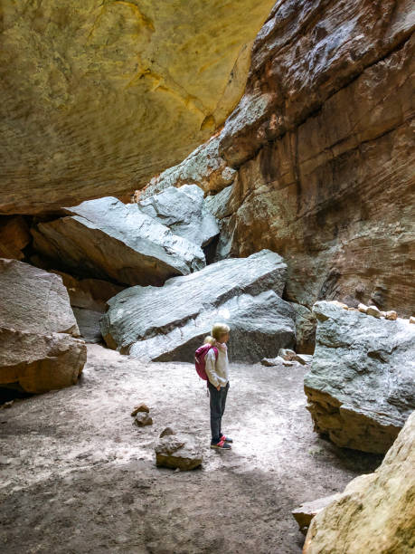istock Young girl standing in a cave 1266787483